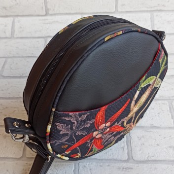 Round bag made of upholstered fabric with flowers, leaves / black leatherette